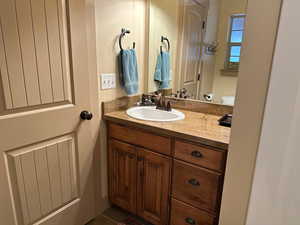 Main level full bathroom with vanity