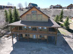 Front view of property with 3 sided covered  deck, a patio area.
