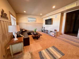 Living area with wainscoting, carpet floors, and recessed lighting