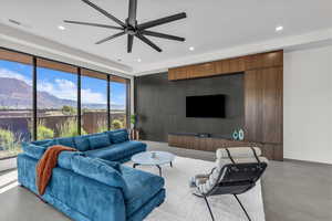 Living area featuring recessed lighting, a ceiling fan, and finished concrete floors