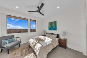 Bedroom with ceiling fan and recessed lighting