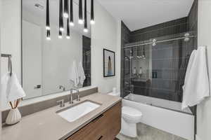 Full bathroom with vanity and combined bath / shower with glass door