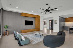 Living room with recessed lighting, a ceiling fan, visible vents, and an accent wall
