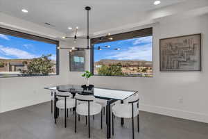 Dining area with plenty of natural light, a chandelier, recessed lighting, and a mountain view
