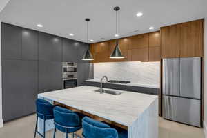 Kitchen featuring a sink, modern cabinets, and stainless steel appliances