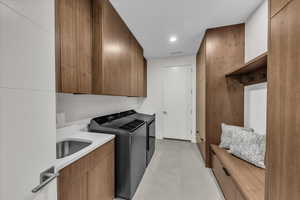 Washroom featuring cabinet space, independent washer and dryer, and recessed lighting