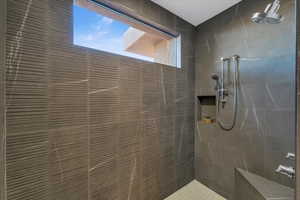 Full bathroom with tiled shower