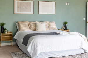 Carpeted bedroom with baseboards