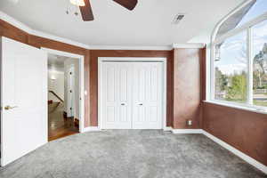 Unfurnished bedroom featuring visible vents, a closet, carpet flooring, and multiple windows