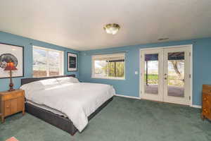 Carpeted bedroom with visible vents, french doors, access to outside, and baseboards
