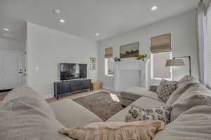 Living room featuring recessed lighting, wood finished floors, and baseboards