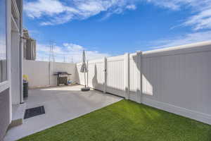 View of patio / terrace with a fenced backyard, visible vents, and grilling area