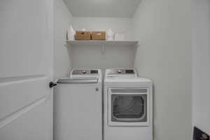 Laundry room with washer and clothes dryer and laundry area