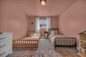 Carpeted bedroom featuring baseboards