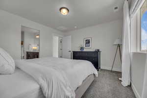 Bedroom featuring visible vents, baseboards, and carpet floors