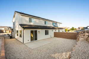 Rear view of property featuring a fenced backyard, stucco siding, central air condition unit, a tile roof, and a patio area