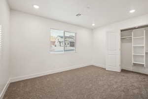 Unfurnished bedroom featuring carpet, visible vents, recessed lighting, and baseboards