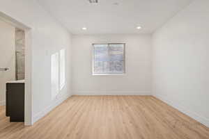 Unfurnished room featuring recessed lighting, light wood-style flooring, and baseboards