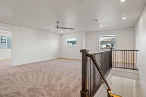 Unfurnished room featuring carpet, recessed lighting, a ceiling fan, and baseboards