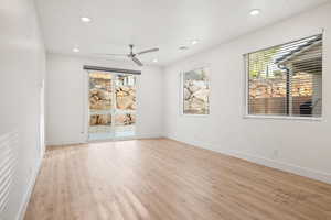 Spare room with a ceiling fan, light wood finished floors, recessed lighting, and baseboards