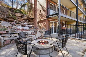 View of patio / terrace featuring a balcony and an outdoor fire pit