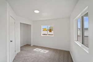 Unfurnished bedroom with a closet, carpet, and baseboards
