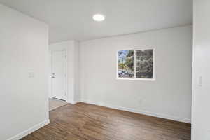 Empty room with wood finished floors and baseboards