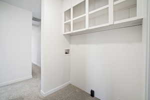 Laundry area featuring hookup for a washing machine, carpet flooring, laundry area, and baseboards