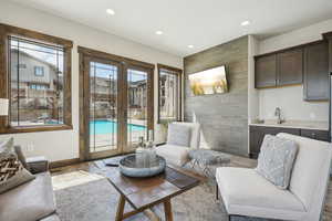 Living area with french doors, recessed lighting, and baseboards