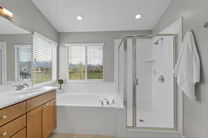 Bathroom featuring a garden tub, vanity, recessed lighting, and a shower stall