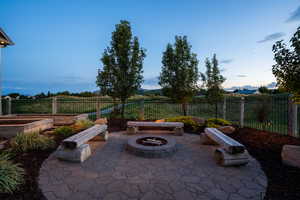 View of patio with a garden, a fire pit, and a fenced backyard