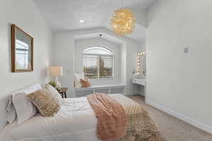 Bedroom with lofted ceiling, a notable chandelier, carpet, and baseboards