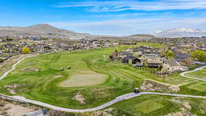 Aerial view featuring a mountain view, golf course view, and a residential view