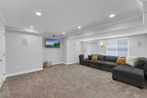 Carpeted living area with recessed lighting, ornamental molding, and baseboards