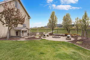 View of yard with a patio, an outdoor fire pit, and a fenced backyard
