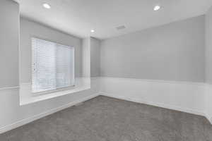 Empty room featuring a healthy amount of sunlight, recessed lighting, and carpet floors