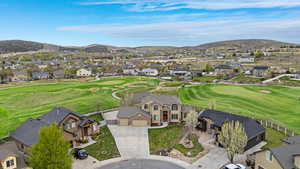 Drone / aerial view featuring a mountain view, a residential view, and view of golf course
