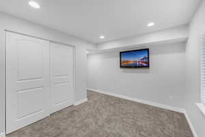 Below grade area with recessed lighting, baseboards, and carpet floors