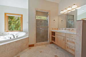 En suite with jetted tub, private shower, double vanity