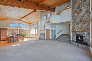 Living room and kitchen with vaulted ceiling and large windows