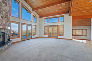 Living room with large windows and double doors leading to the expansive deck