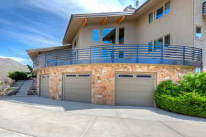 Front view of house with 3 car garage and deck