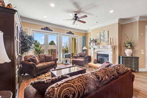 Living area, baseboards, a glass covered fireplace, recessed lighting, and ceiling fan & panoramic view