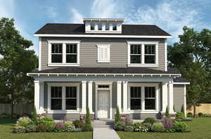 View of front facade featuring fence, roof with shingles, and a front yard
