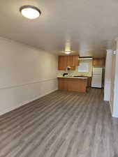 Kitchen with refrigerator, a breakfast bar, and open floor plan