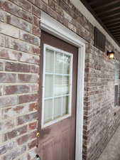 Property entrance with brick siding