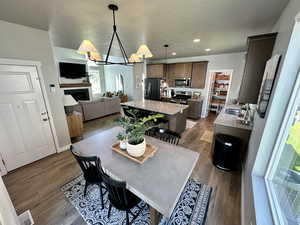 Dining room featuring a fireplace, recessed lighting, visible vents, and dark wood finished floors
