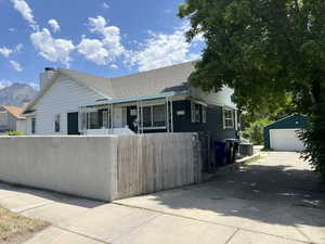 Single story home with a garage, an outbuilding, fence private yard, driveway, and central AC