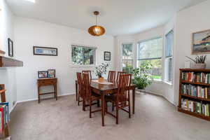 Dining space with light colored carpet and baseboards