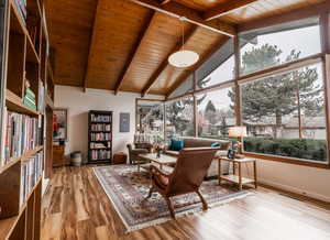 Interior space with beam ceiling, visible vents, baseboards, wood ceiling, and wood finished floors